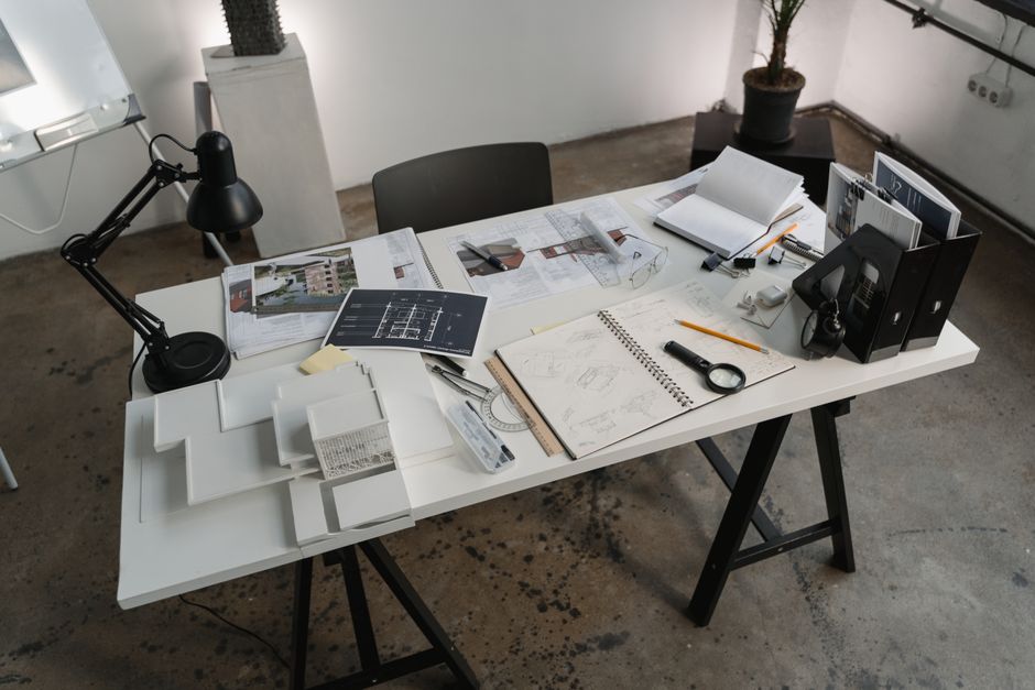 Basement floor plan and permit paperwork on a table