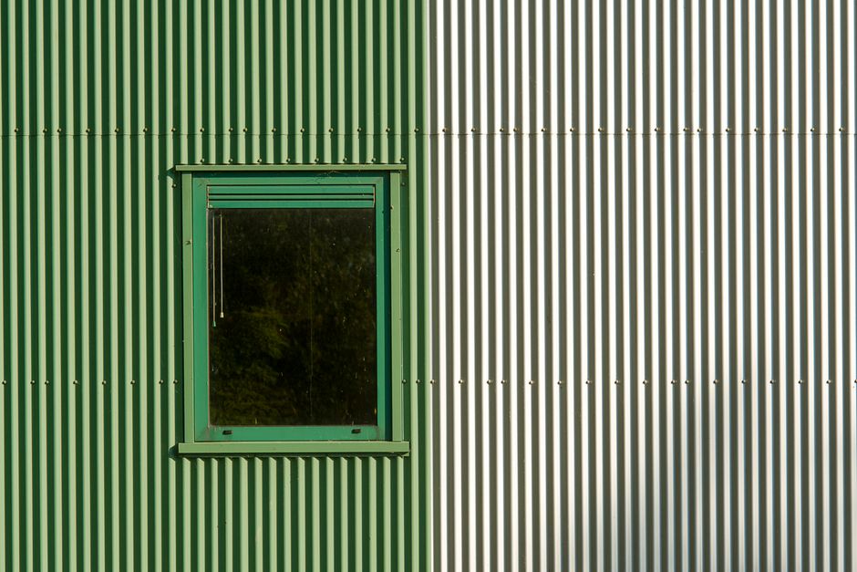 Corrugated metal, poly, and precast concrete window wells shown side by side