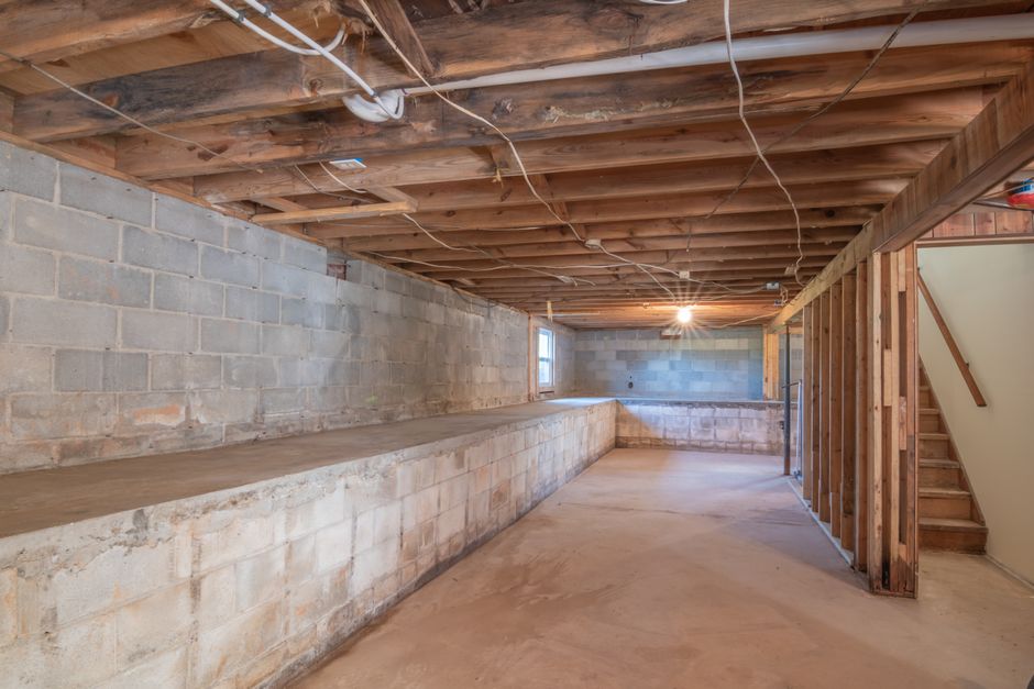 Basement egress window and window well installed against a home's foundation