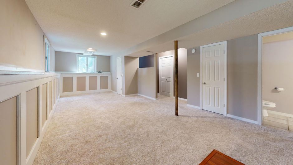 A replaced basement window set into an existing foundation opening
